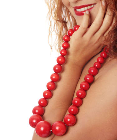 Close up portrait of beautiful redhead woman with big ,red,vintage, wooden beadsの写真素材