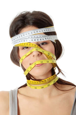 Beautiful young caucasian woman with measuring tape around her head, isolated on white. Diet concept