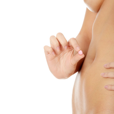 Woman holding pink pill against her nude body. Diet suplement conept