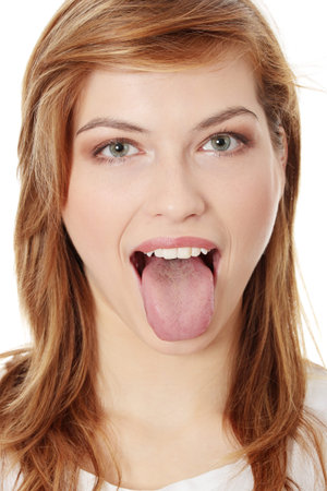 Young cheerful girl showing tongue