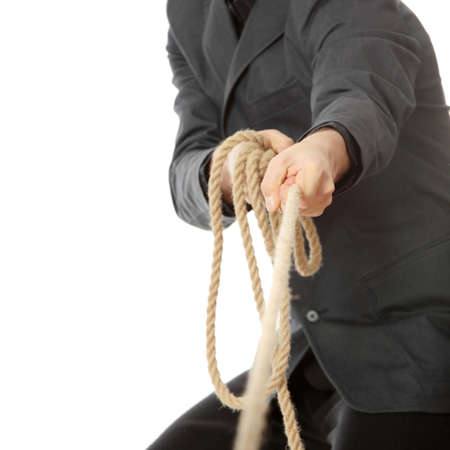 Businessman pulling on a rope. Isolated on whiteの写真素材