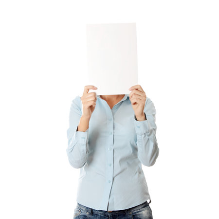 Photo of young girl covering her face with blank board,isolated on whiteの写真素材