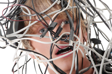 Businessman wrapped in computer cablesの写真素材