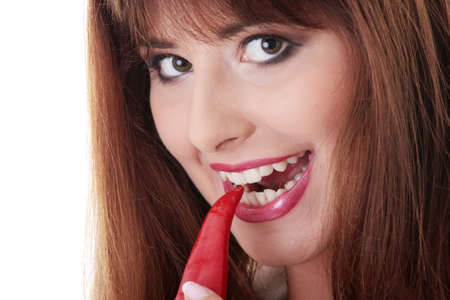 Hot sexy woman eating red hot chile pepper の写真素材
