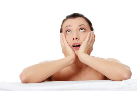 Young amazed beautiful caucasian woman after bath isolated on white の写真素材