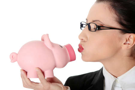 Businesswoman holding piggy bank isolated on whiteの写真素材
