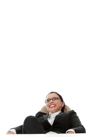 Young businesswoman relaxing at the desk, over white backgroundの写真素材