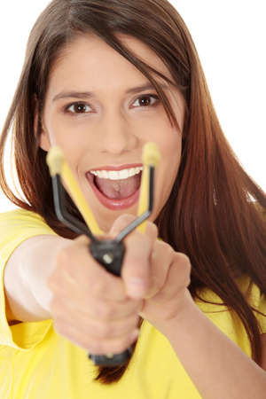 Happy young woman with slingshot, aiming at youの写真素材