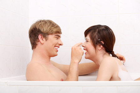 Young happy couple taking bath together. の写真素材
