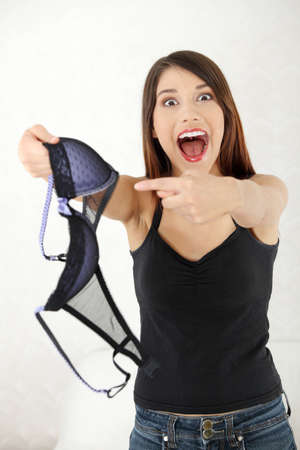 Angry woman with bra in hand. Betrayal conceptの写真素材