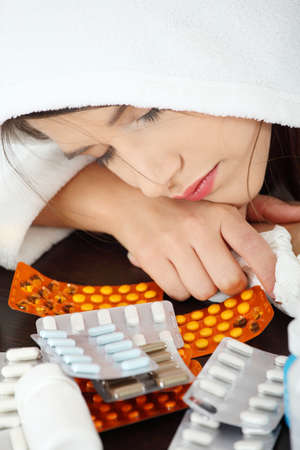 Sick young woman in bathrobeの写真素材