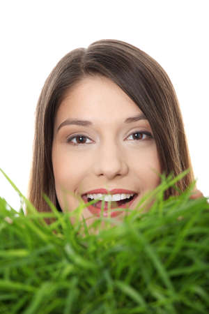 Beautiful young woman relaxing in the grass の写真素材