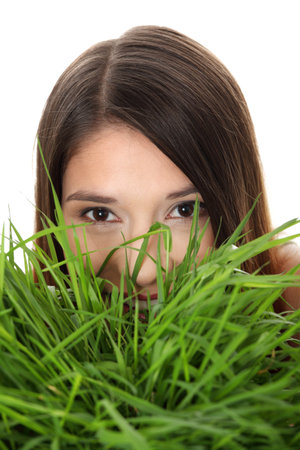 Beautiful young woman relaxing in the grass の写真素材