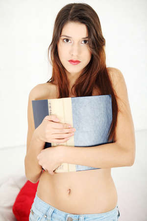 Beautiful topless woman with a bookの写真素材