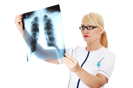 Female doctor looking at an x-ray, isolated on white