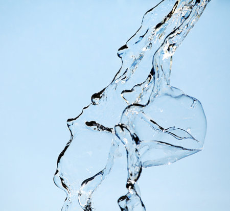 Water splash. Over blue background.の写真素材