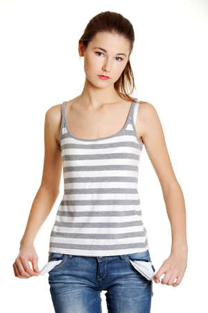 Front view of a sad young female caucasian teen taking out empty pockets, on white.の写真素材