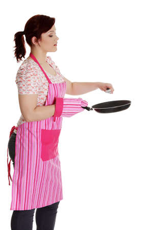 Happy woman in pink kitchen apron. Isolated on white backgroundの写真素材