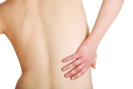 Young woman with pain in her back. Isolated 