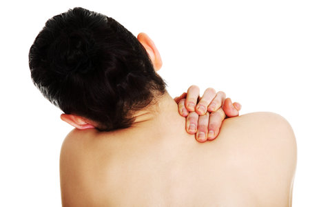 Young woman with pain in her back. Isolated 