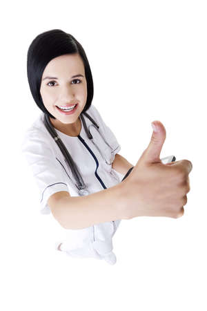 Young female doctor or nurse gesturing OK , isolatedの写真素材