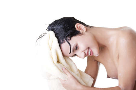 A young woman with wet hair in white robe toweling off after a shower.の写真素材