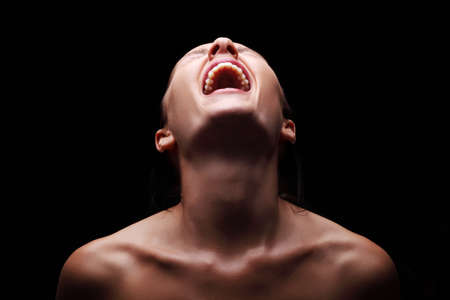 Screaming woman over black backgroundの写真素材