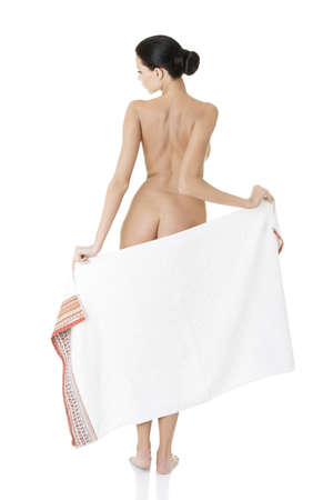 Rear view of young beautiful nude woman with towel , isolated on white の写真素材