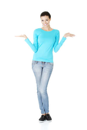 Happy , excited young woman presenting copy space on her palm, isolated on white の写真素材