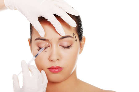 Cosmetic botox injection in the female face, eye and eyebrow zone の写真素材
