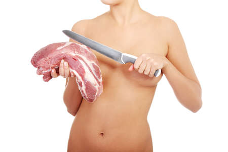 Nude woman holding big part of raw meat (pork neck) and knife. Protein diet concept. の写真素材