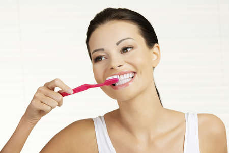 Woman with great teeth holding tooth brush の写真素材