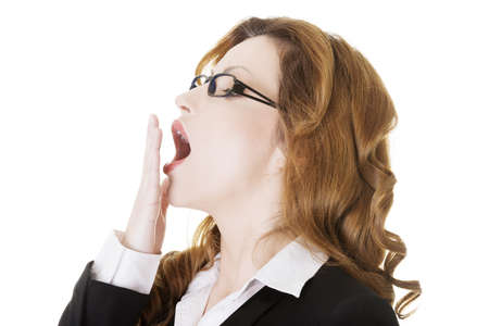 Tired business woman in a suit ,isolated over white backgroundの写真素材