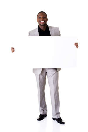 Happy successful businessman holding and showing blank advertisement. Isolated on white.の写真素材