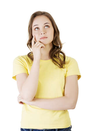 Beautiful teenage girl is thinking. Isolated on white background の写真素材