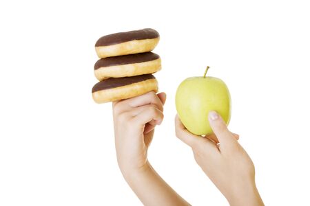 Donut or green apple - hard choice. Diet concept.の写真素材