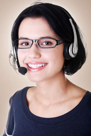 Closeup of attractive customer support representative smiling with headset on brown background の写真素材