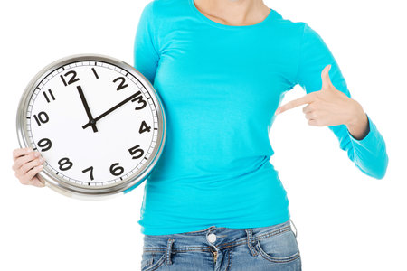 Attractive woman with a clock. Close up. Bodypart. Isolated on white. 