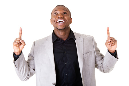 Handsome male businessman pointing up with fingers. Isolated on white. の写真素材