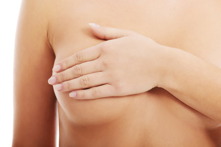 Close up on female chest. A woman is touching her breasts. の写真素材
