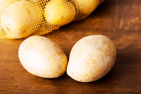 Fresh potatoes.Over wooden background.の写真素材