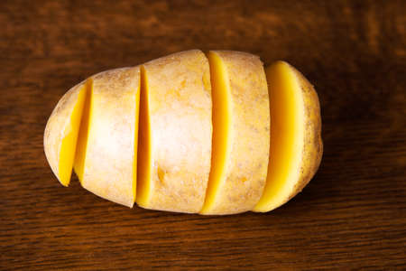 Fresh potatoes.Over wooden background.の写真素材