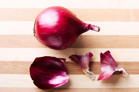 Red onion  over wooden background.の写真素材