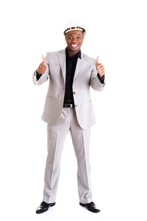 Happy successful businesman in helmet gesturinh thumbs up. Isolated on white.の写真素材