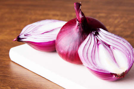 Red onion  over wooden background.の写真素材
