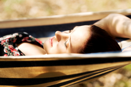 Young woman lying in hammock.の写真素材