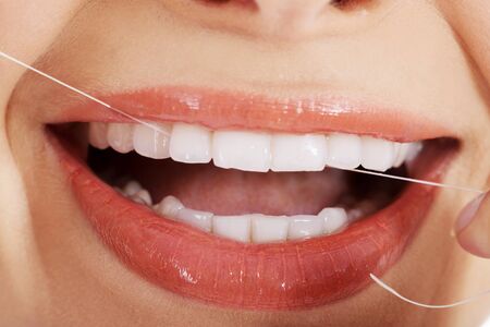 Young beautiful woman with dental floss.の写真素材