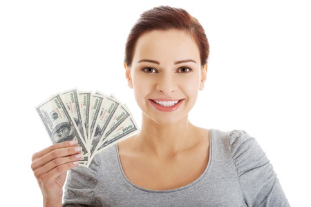 Casual woman holding money - dollars.の写真素材
