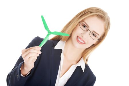 Beautiful caucasian business woman with green propeller. Isolated on white.の写真素材