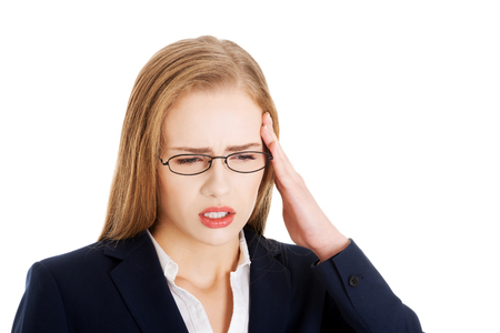 Beautiful business woman is having a headache. Isolated on white.の写真素材